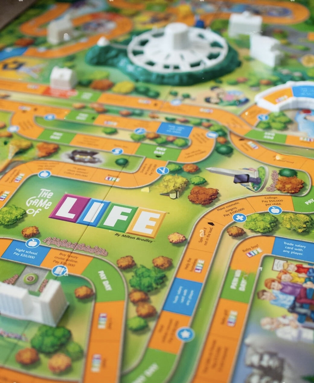 Image of the Game of Life board game, including the board path, LIFE logo and the spinning wheel